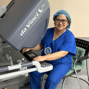dr. jenny jose a gynecologist in Philippines sits in her clinic, expertly using an advanced robotic surgery equipment.